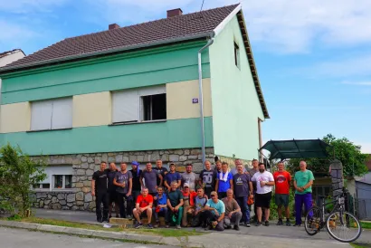 Grupna fotografija ispred kuće s obnovljenim krovom snimljena u ponedjeljak u 17 sati/Foto: Nikica Puhalo